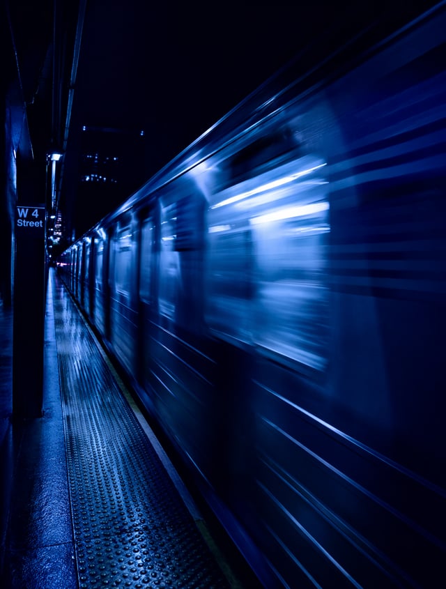 Blurred motion of a subway train at night. deep blue pallete
