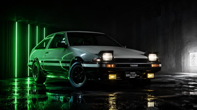 Cinematic automotive studio shot of a Toyota Sprinter Trueno AE86, facing 45 degrees left. Environme