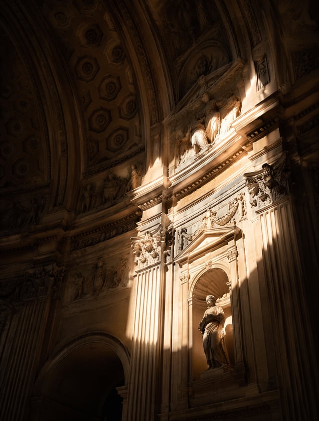 A stunning interior architectural photograph looking up at the curved walls and vaulted ceilings of 