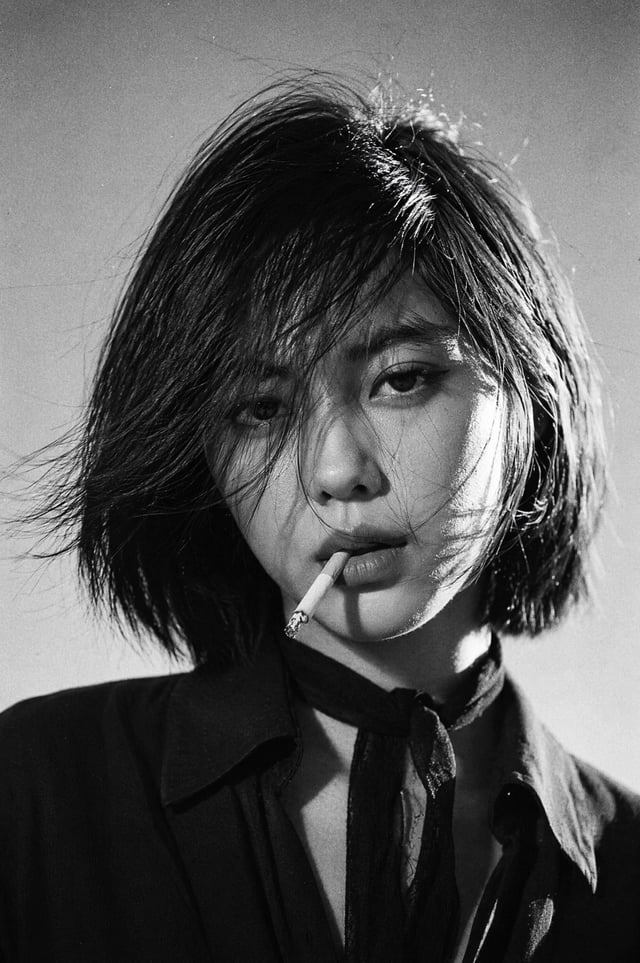 Create a 1970s black-and-white close-up portrait in a windswept outdoor setting, black and white noi