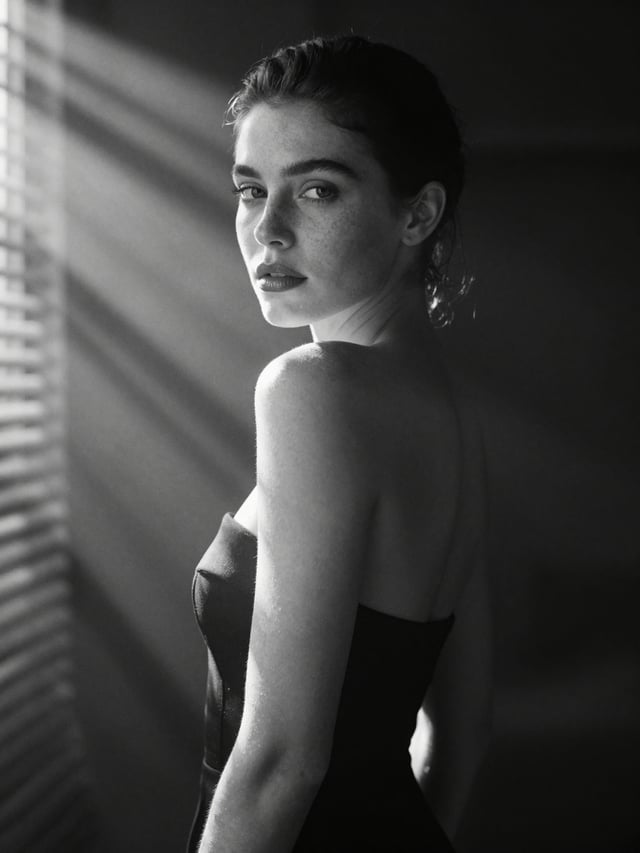 A hyperrealistic 8k black and white cinematic mid shot portrait of a beautiful woman with natural fr