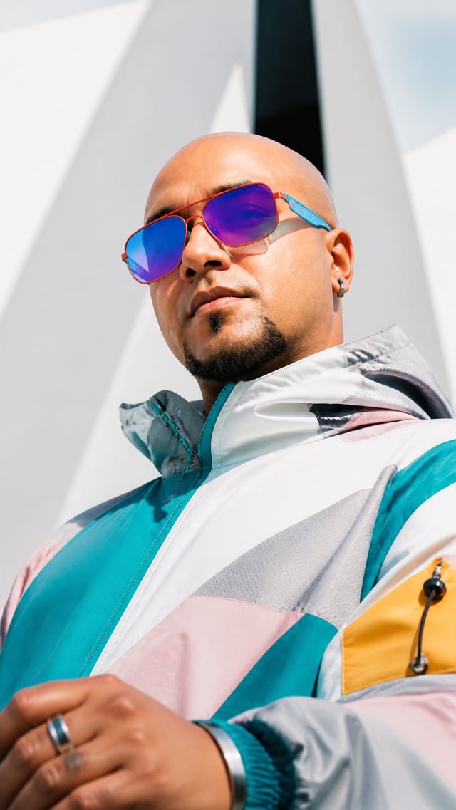 Create image A high-fashion, cinematic portrait of a stylish young man with a sharp, modern editoria