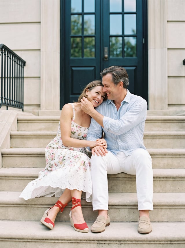 On a quiet afternoon, a relaxed, romantic moment unfolds on the steps of a classical building: the m