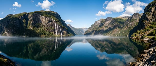 Cinematic landscape of dramatic Norwegian fjord with vertical cliff walls, crisp clear midday with s