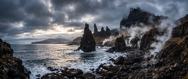 Cinematic landscape of dramatic Scottish Isle of Skye with sea stacks, soft reflected light from wat