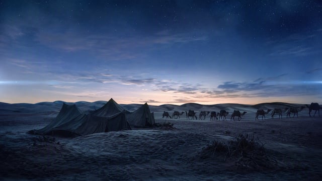 Documentary landscape photography capturing an ancient desert caravan at dusk. A cluster of weathere