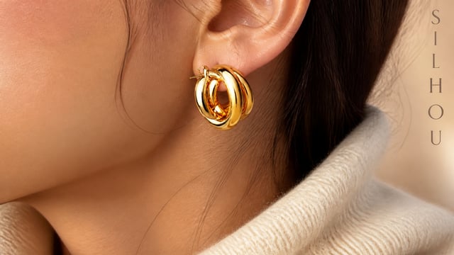 Use the uploaded earrings image as the exact product reference. The earrings must remain identical t