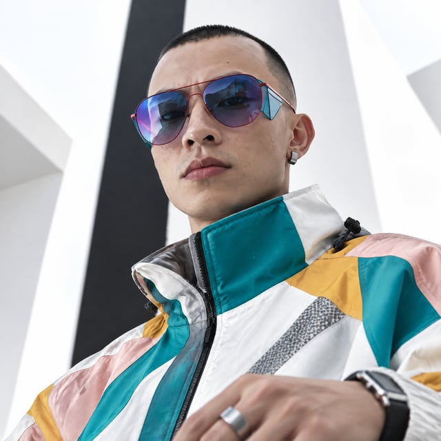 Create image A high-fashion, cinematic portrait of a stylish young man with a sharp, modern editoria