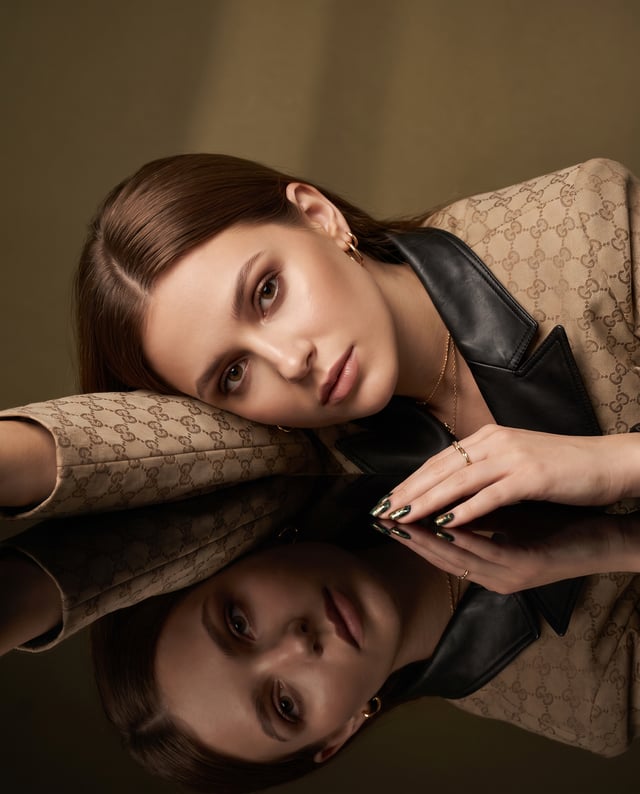 Create a hyper-realistic cinematic fashion portrait of a young adult woman lying gracefully with her