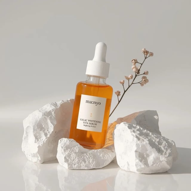 Minimalist studio product photography of an amber glass dropper serum bottle with white cap, labeled