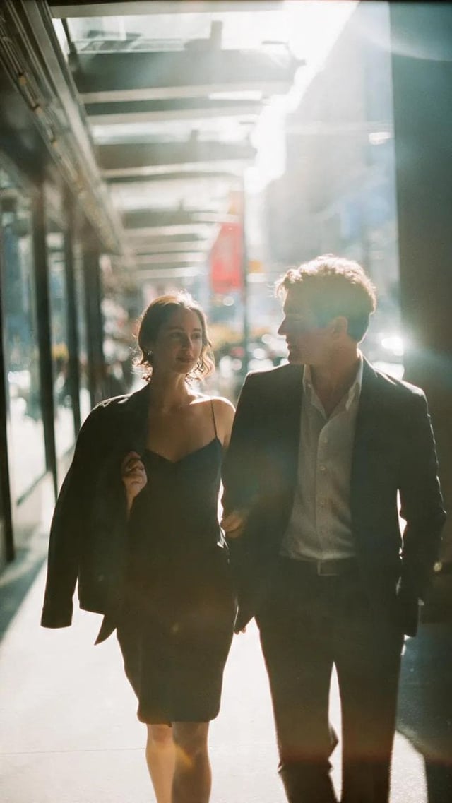 A cinematic candid medium shot portrait of a man and a woman walking side by side along a bright urb