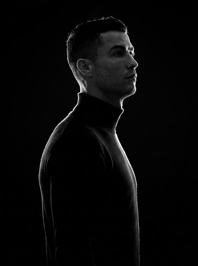 A minimalist black and white cinematic portrait featuring two individuals (male and female) in stric