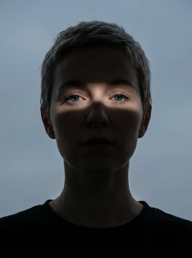 Close-up portrait of a woman (Same face as reference image)looking directly at the camera. Her face 