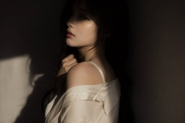 editorial portrait, Korean female idol, subtly sensual  outfit: silk shirt or soft fabric top, sligh
