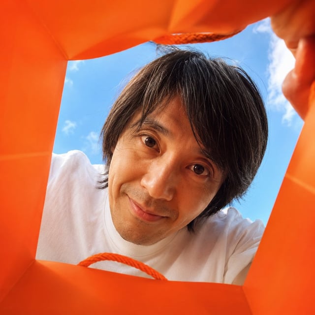 Create a vibrant, adorable, high-end advertising photo shot from inside a shopping bag, looking upwa