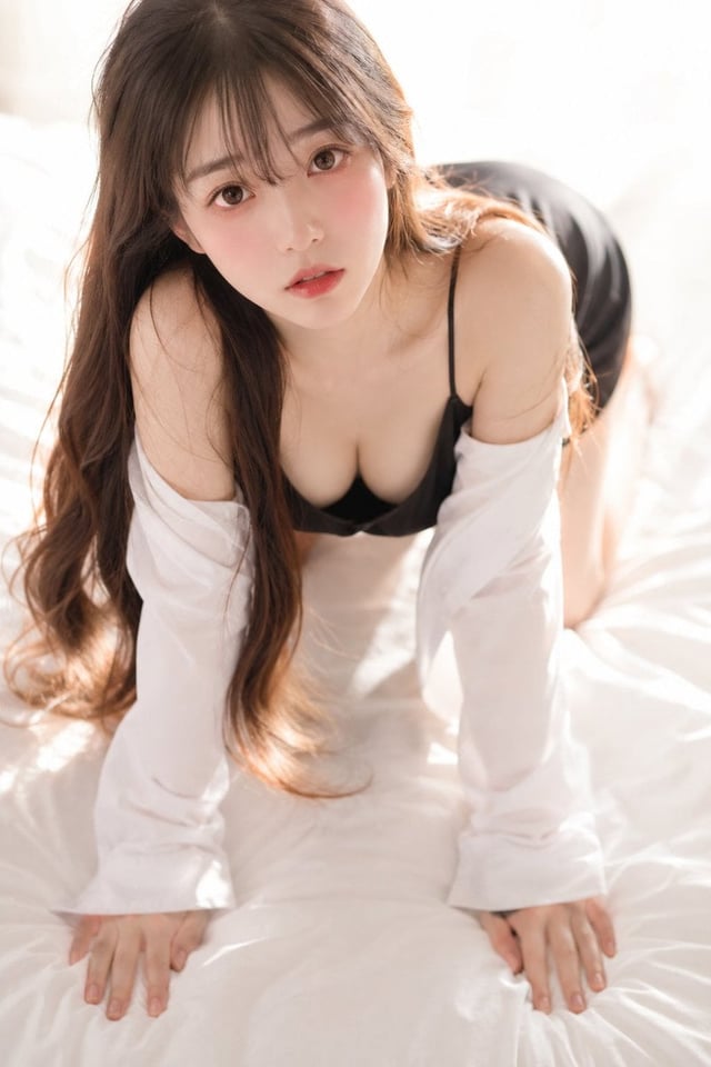 A soft, intimate 35mm photograph shot from slightly above, looking down at a beautiful young East As