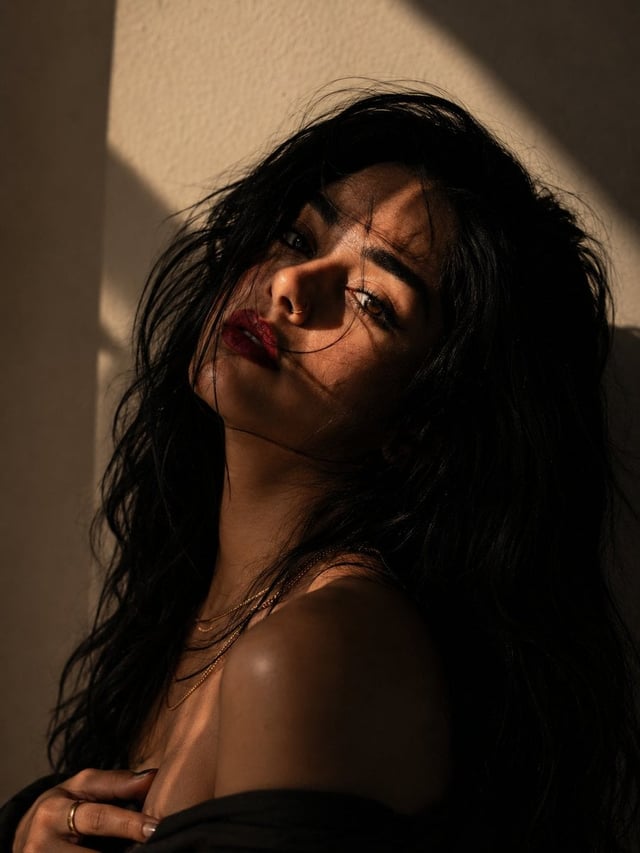 Create an ultra-realistic, cinematic fine-art portrait of a beautiful young woman with a moody, edit