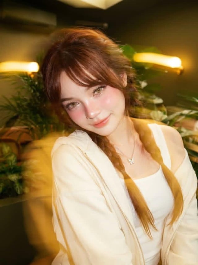 Ultra-realistic portrait of a beautiful young woman sitting in a cozy modern indoor café corner fill