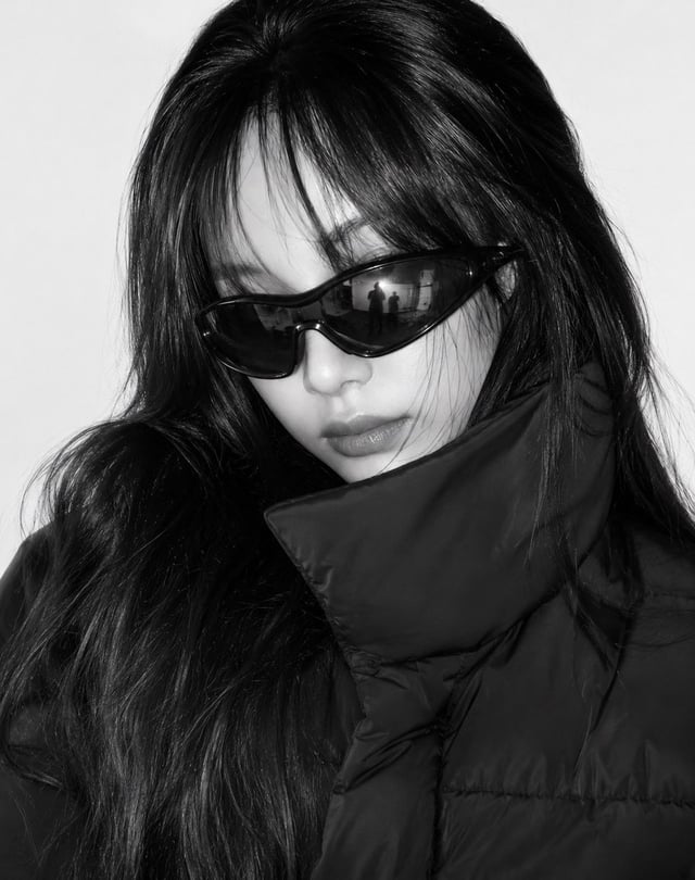 Create a close-up black-and-white high-fashion editorial portrait using the uploaded photo as the fa