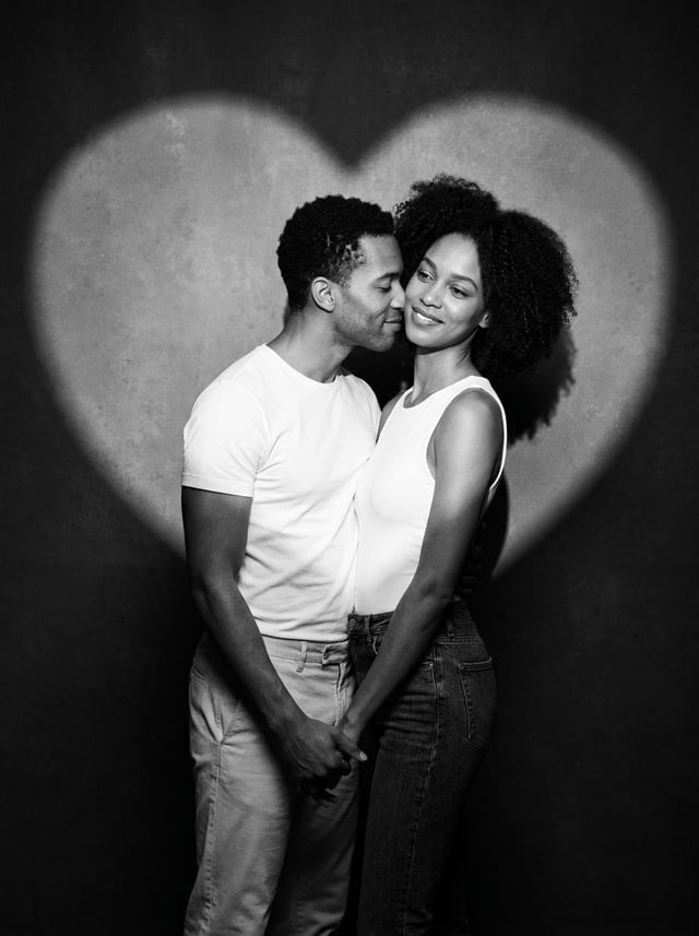Create a romantic black-and-white studio portrait of a real skinny, not medium weighed, couple stand