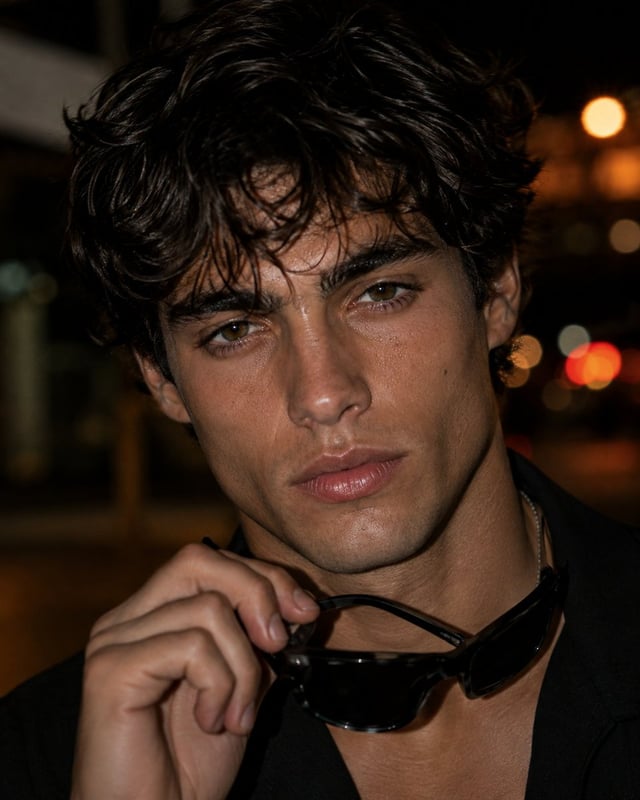 Photorealistic close-up editorial portrait of a young adult man with short, tousled dark brown hair,