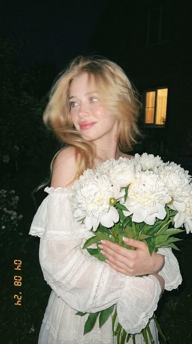 A spontaneous shot, caught by chance. A nighttime garden, disposable film camera, the girl positione